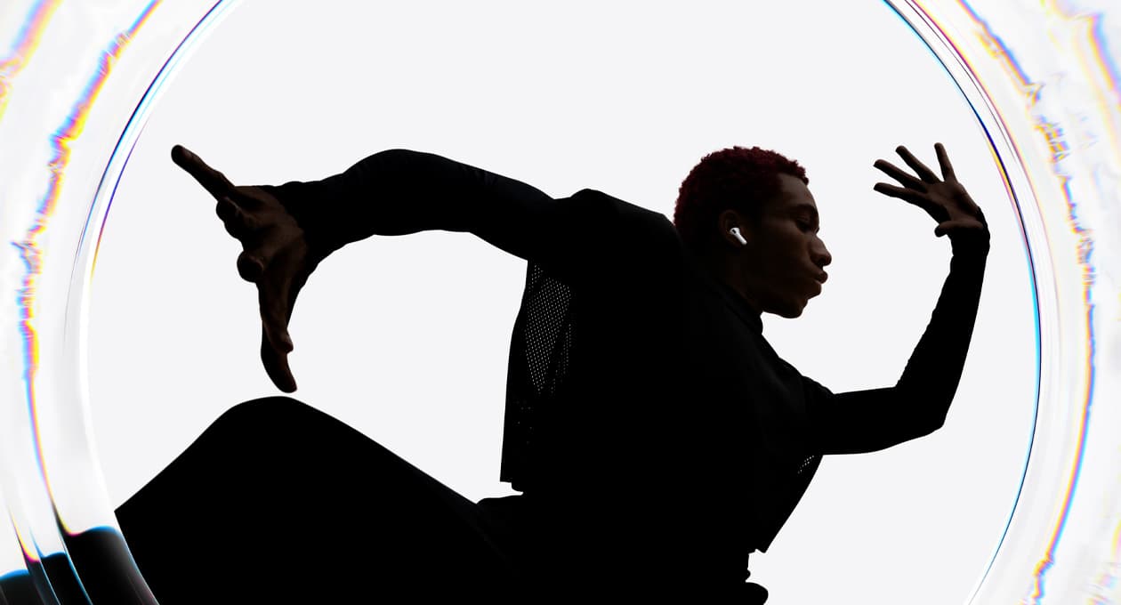 A dancer uses AirPods Pro 3 as they move to a beat with their arms spread wide