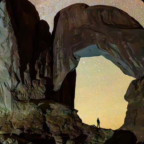 iPad Pro display showing a photograph of a person in a canyon and a star-filled night sky