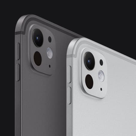Two iPad Pro devices, back and side exterior, portrait orientation, space black color and silver color, volume-up button, volume-down button, pro camera system