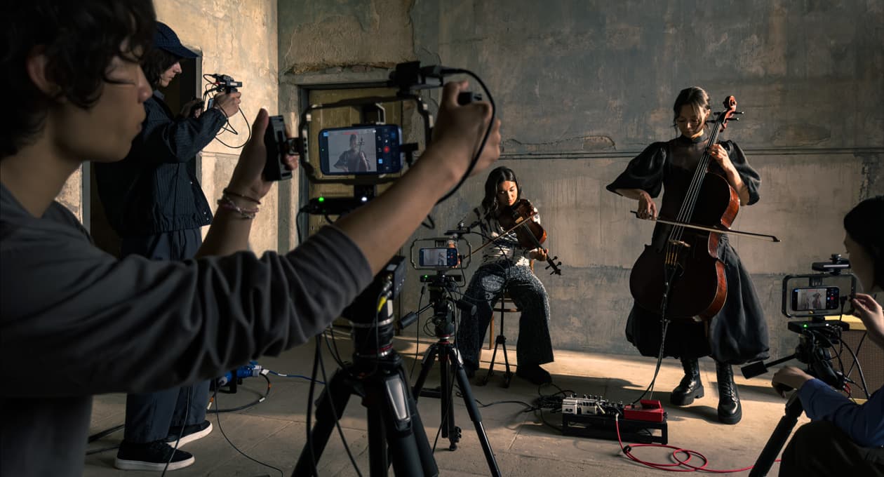 iPhone 17 Pro sits on a tripod showing the genlock and timecode support feature while recording during a film shoot